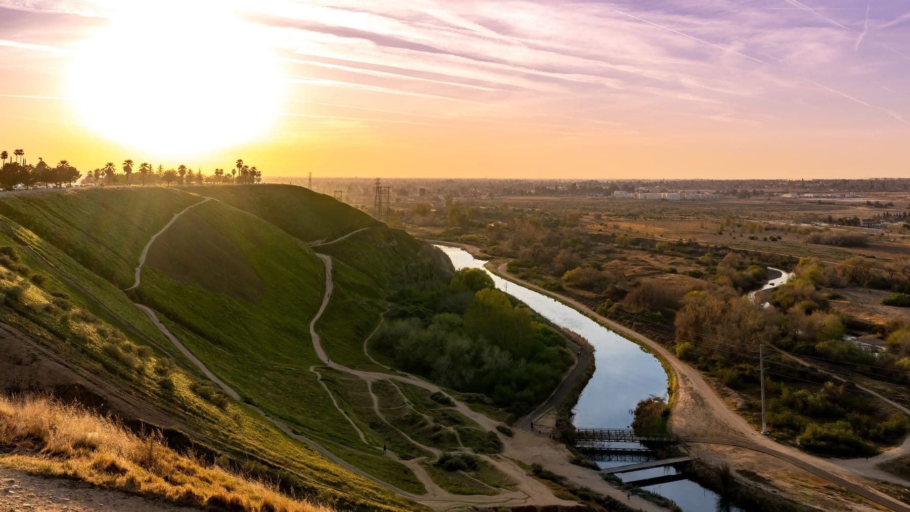 Kern River and grassy bluffs in Bakersfield at sunset