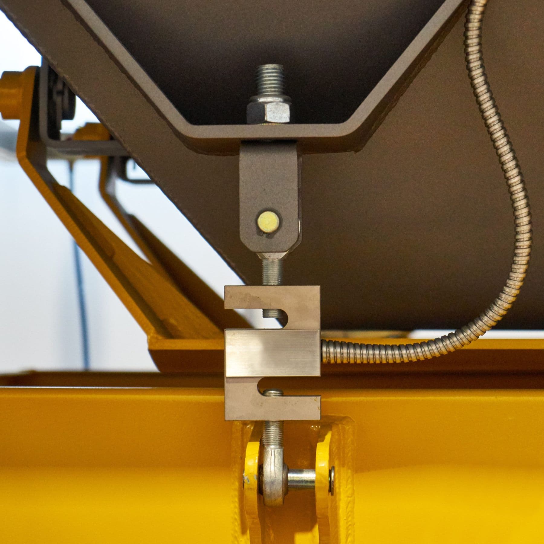 Load cell and mounting hardware supporting an industrial hopper