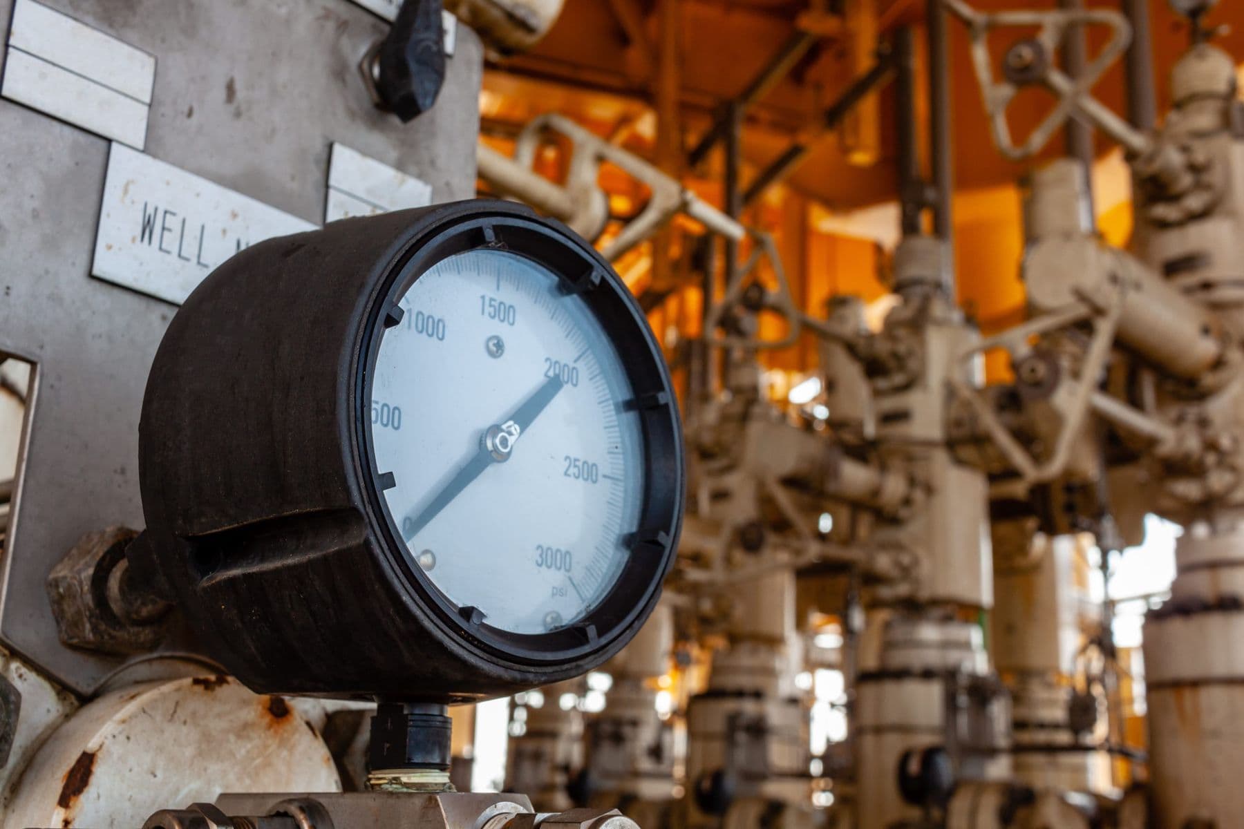 Analog pressure gauge on industrial pipework