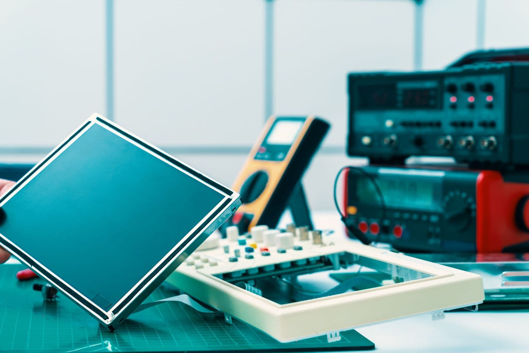 Disassembled electronic instrument on a repair bench