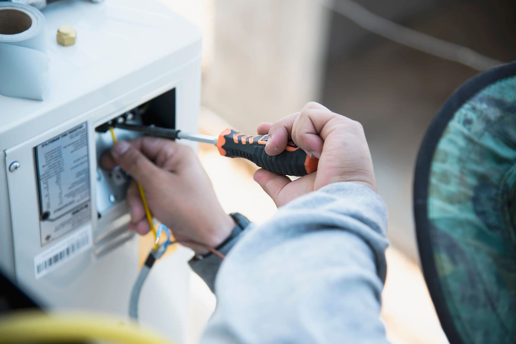Technician servicing medical equipment with a screwdriver