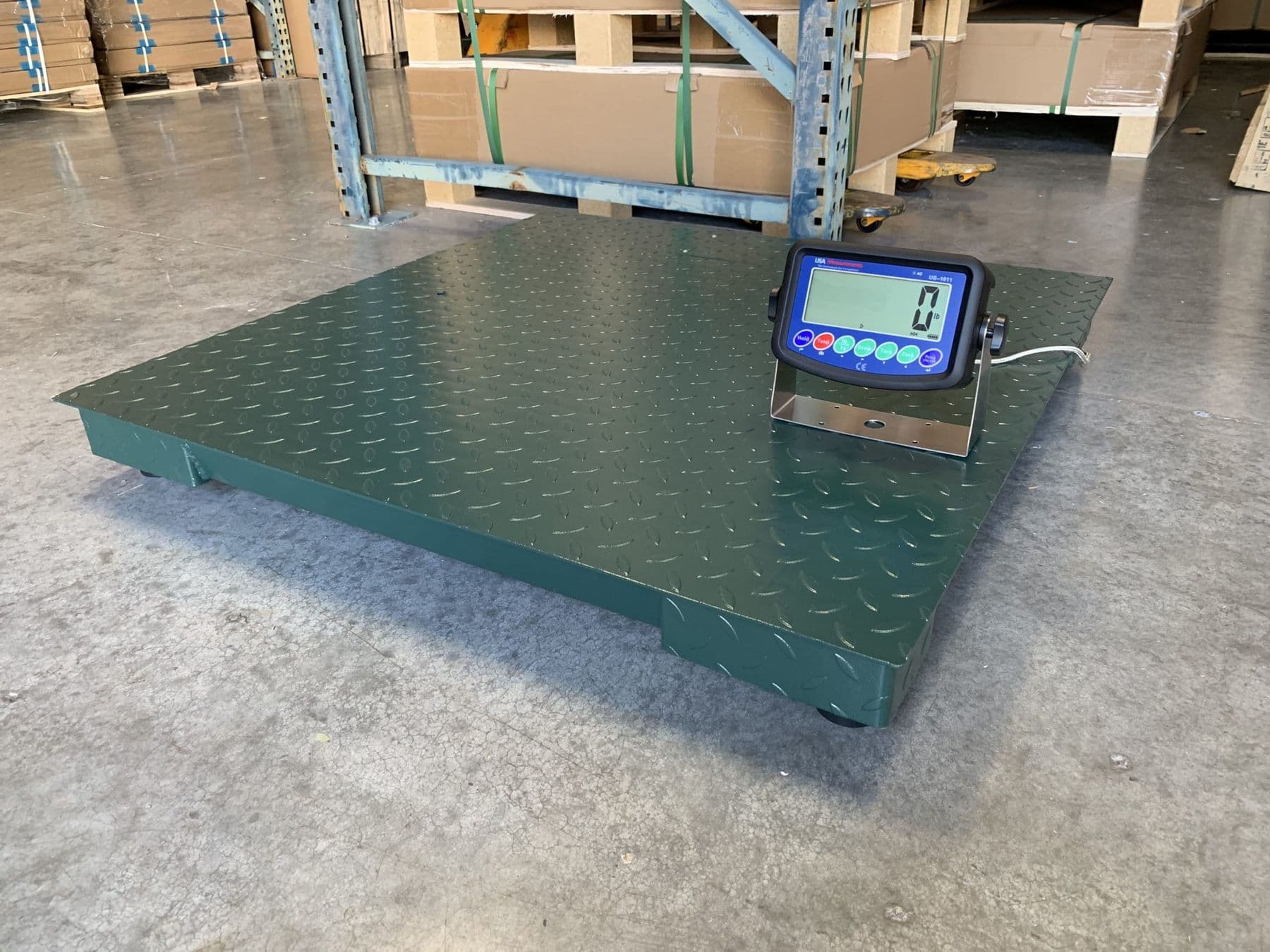 Diamond-plate floor scale with digital indicator installed in a warehouse