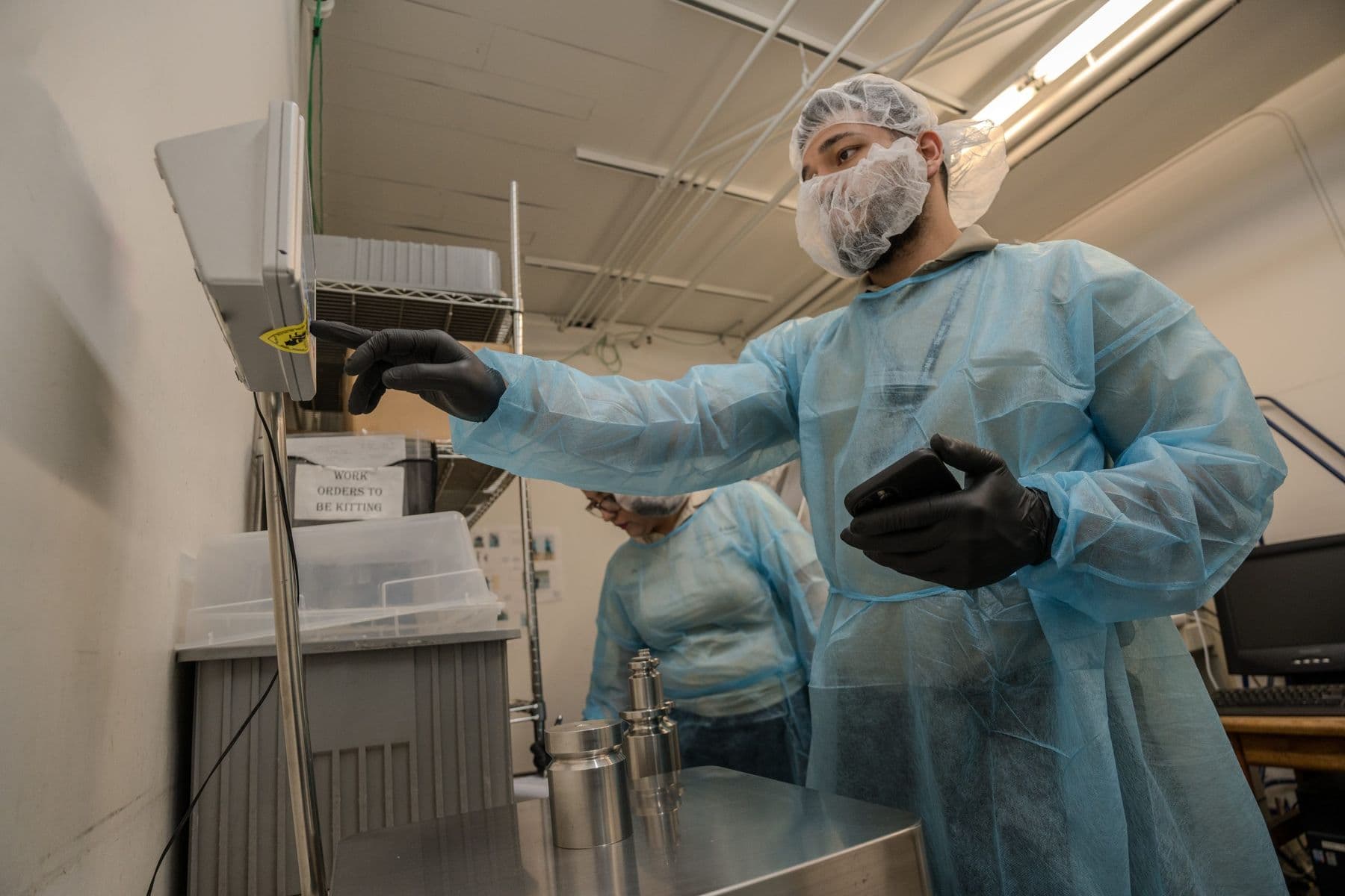 Technician checking a bench scale indicator during calibration