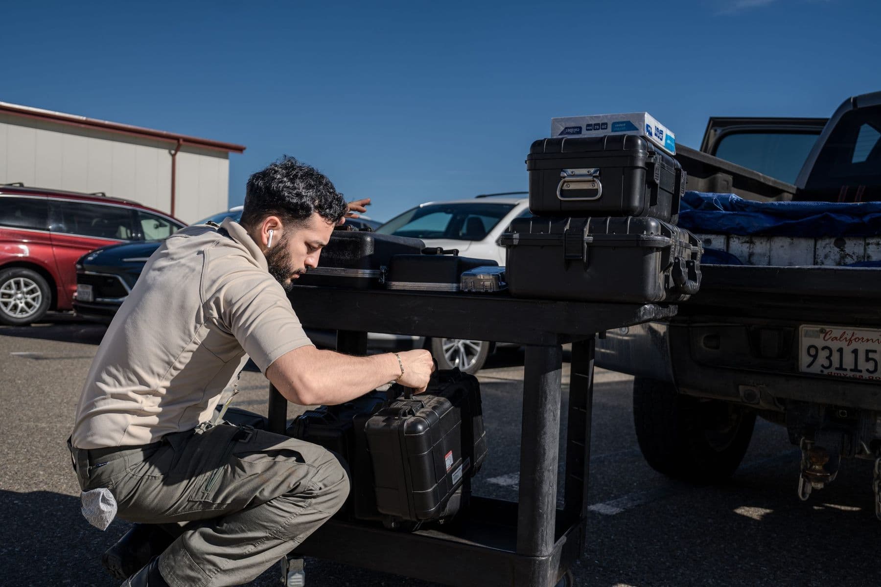 Technician preparing equipment cases beside a service truck for on-site calibration
