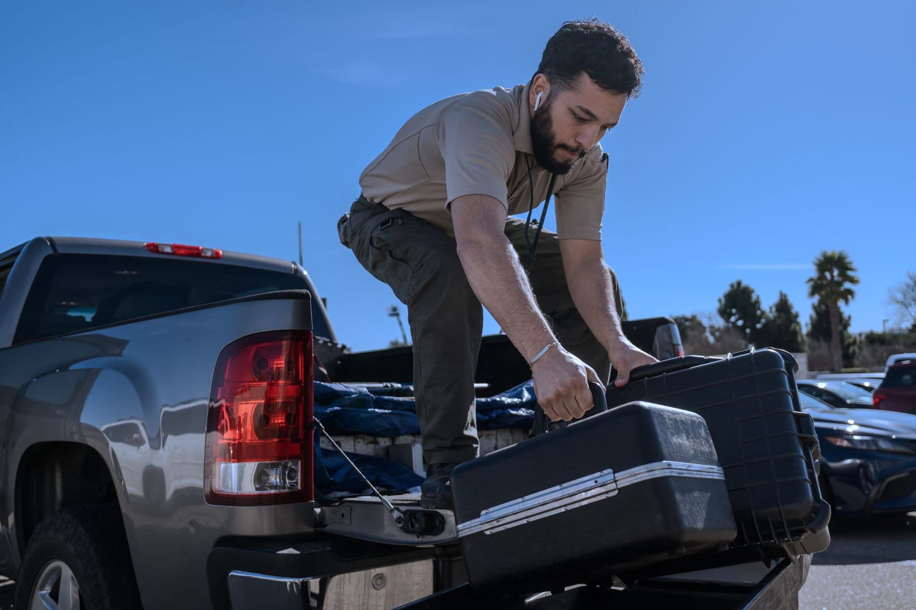 MS Weights & Scales technician unloading equipment cases from a service truck