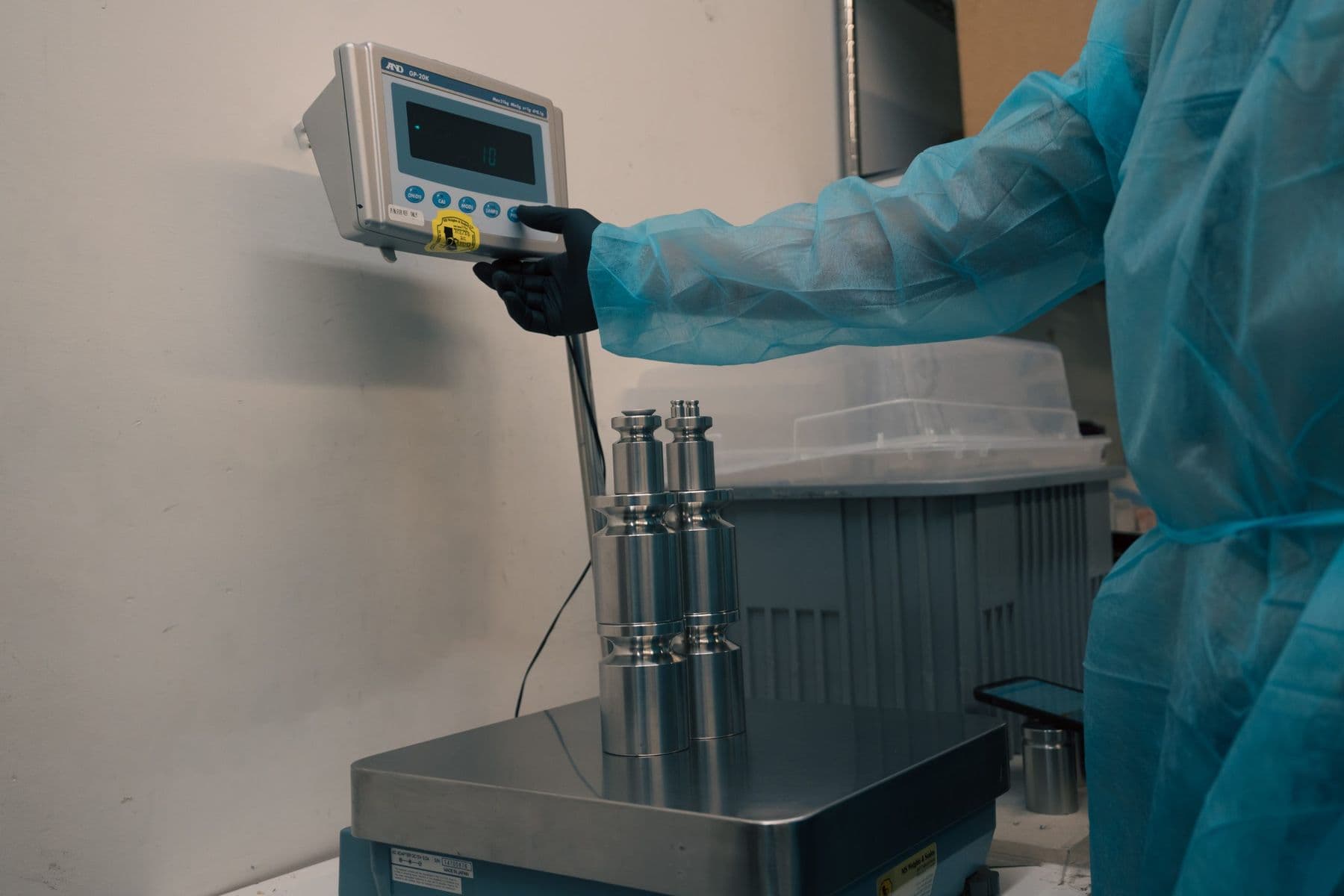 Technician operating a scale indicator during a test-weight calibration